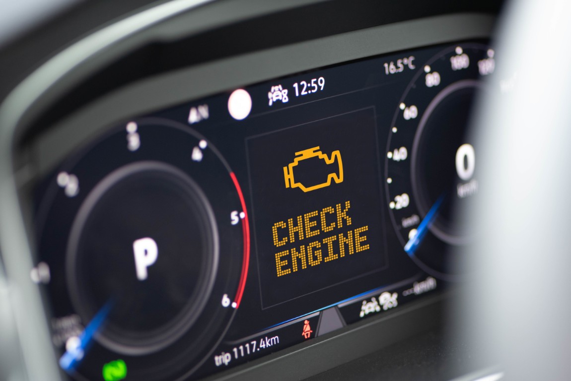 Amber check engine warning illuminated on a vehicle's instrument cluster.