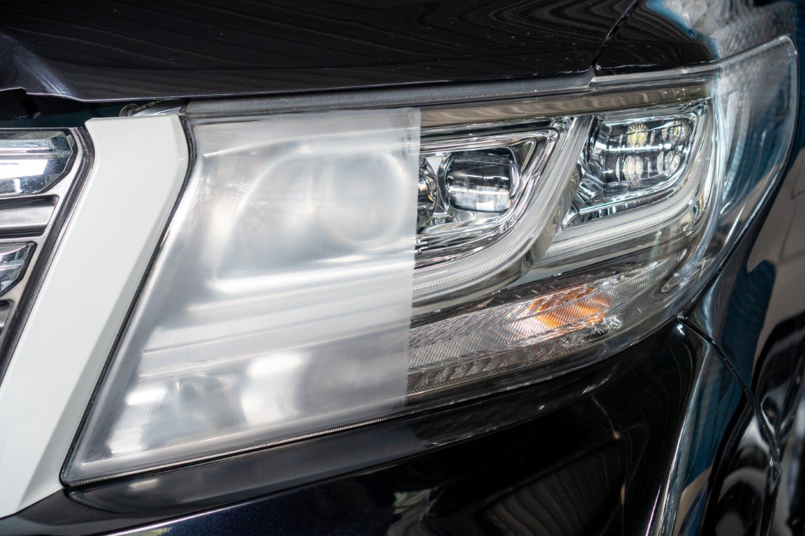 Headlight lens shown half hazy and half restored to clear after restoration